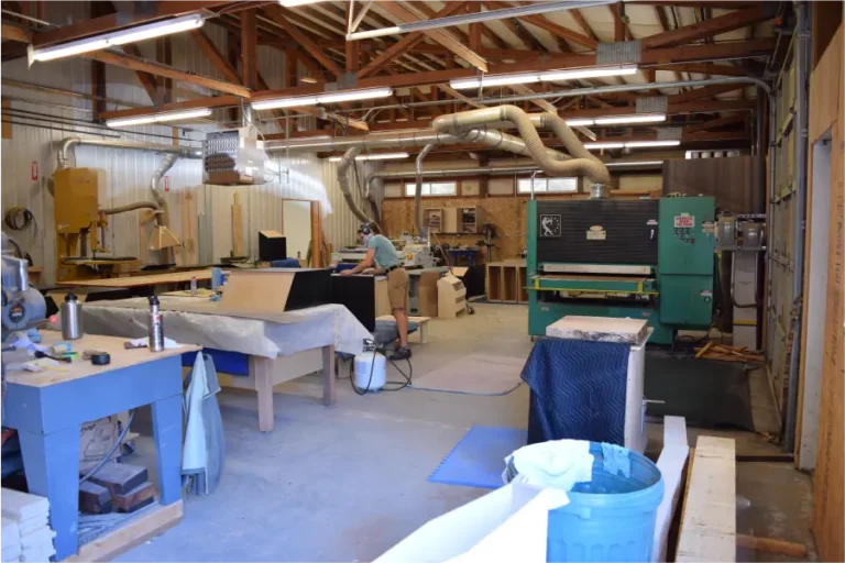 Workshop with various woodworking tools on a table.